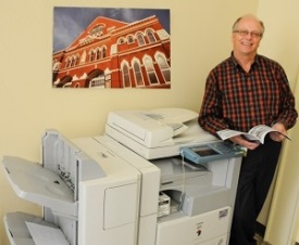 man standing at copy machine