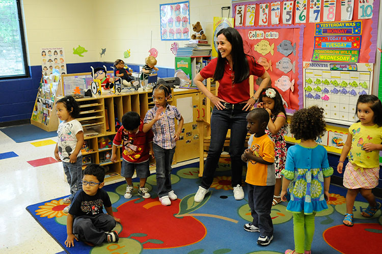 Teacher dances with Head Start children