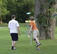 Two people playing disc golf