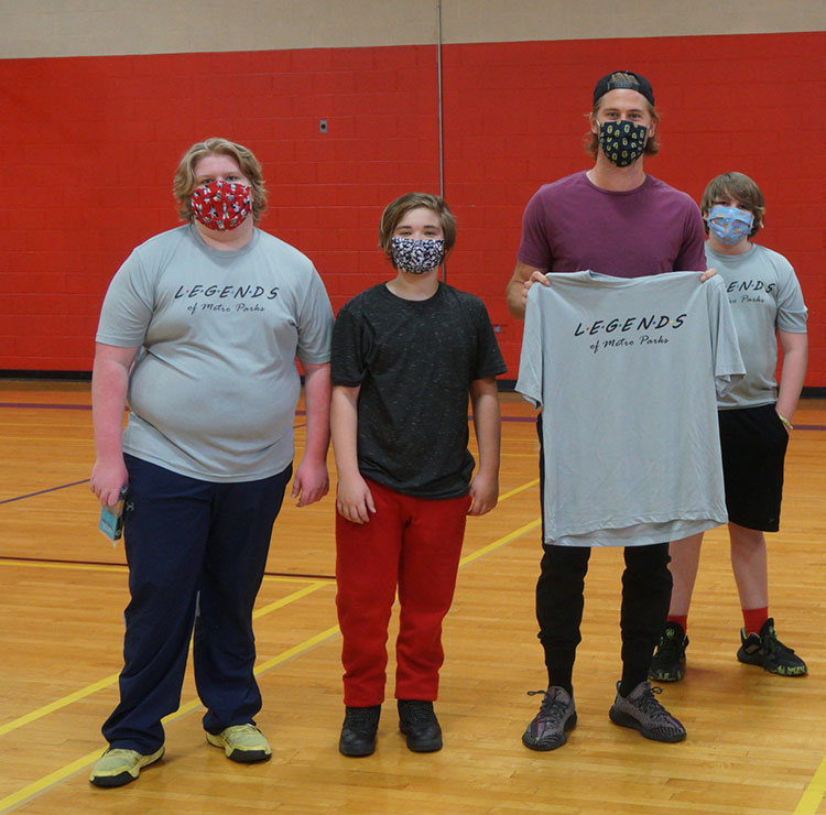 Walker Zimmerman standing with 3 young fans in Old Hickory Community Center gym