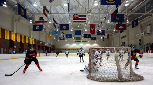 pee wee hockey game; children playing ice hockey