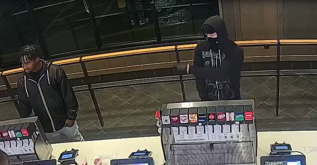 Robbery suspect and unknown customer