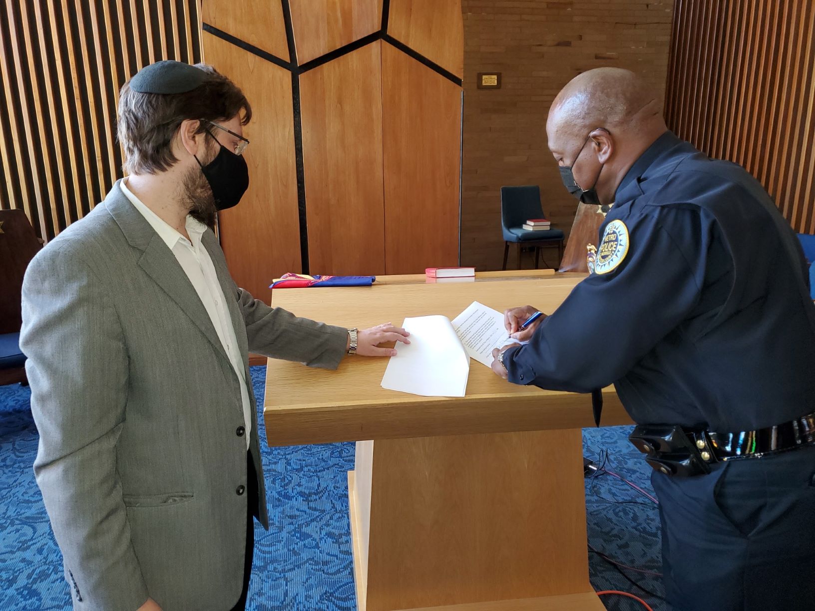Chief Drake and Rabbi Kullock sign ownership paperwork