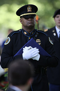 officer with folded flag