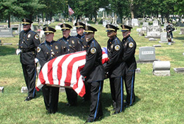 team members carry casket