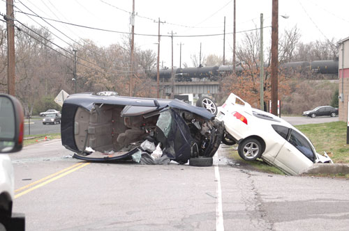 two-car crash; one car on its side