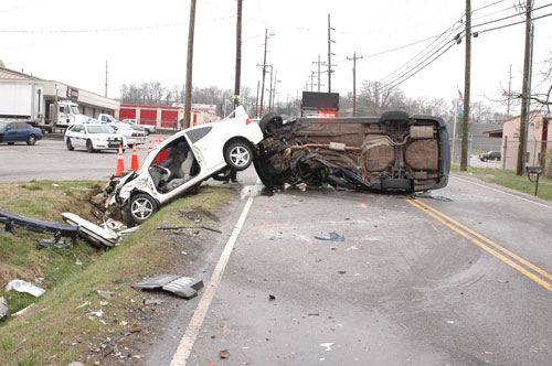 alternate view of the two-car crash; one car on its side