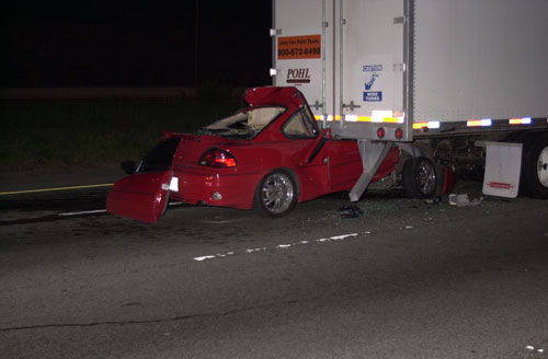 car crashed head-on into the back of tractor trailer truck