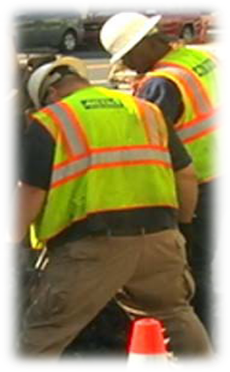 Employee wearing the uniform: tan pants and Water Services logo on safety vest.
