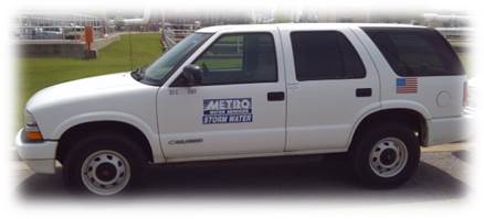 Vehicle - white vehicle with blue Metro Water Services Stormwater logo on side.