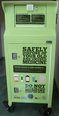 Medicine disposal box with text: Safely dispose of your old and unused medicine, do not flush or pour medicine down the drain