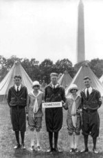TN 4-H delegation - 2 girls and 3 boys- standing in front of pitched tents on the grounds in front of the washington monument in DC. holding a plaque that says Tennessee, circa 1927