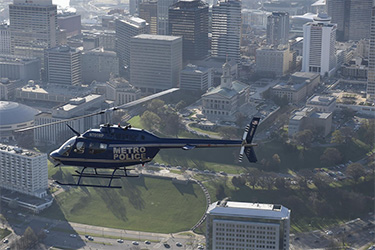 Bell helicopter flying over downtown Nashville