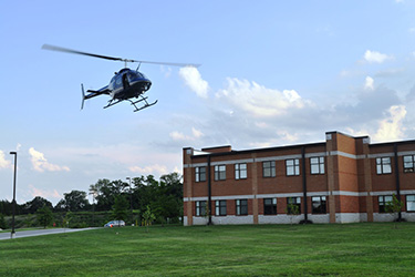 Another view of helicopter flying over building