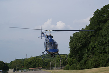 Helicopter flying above road