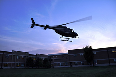 Helicopter flying over building