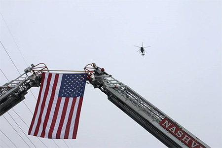 helicopter flying over US flag